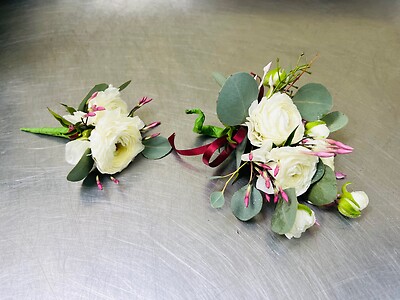 A Wrist Corsage and Boutonniere Combination - All White Rununculus
